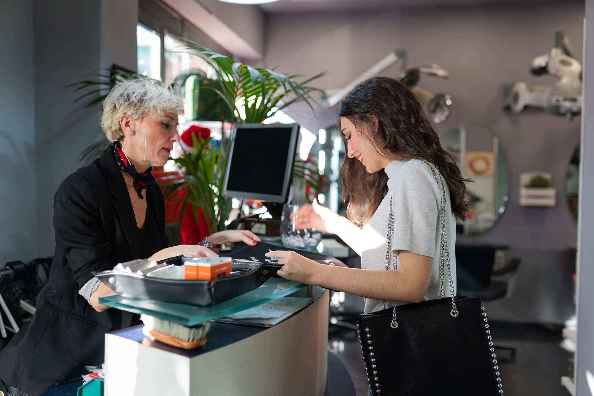 Kundin bezahlt an der Kasse eines Beauty-Salons